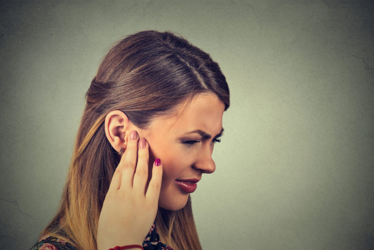 a beautiful woman has a problem with ear pain