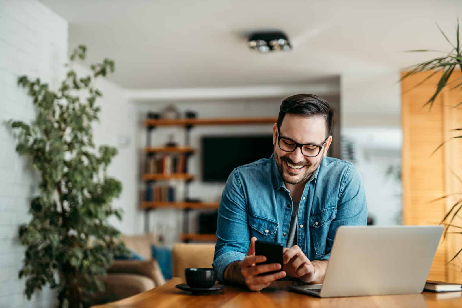 a man sits at a desk and buttons on the phone