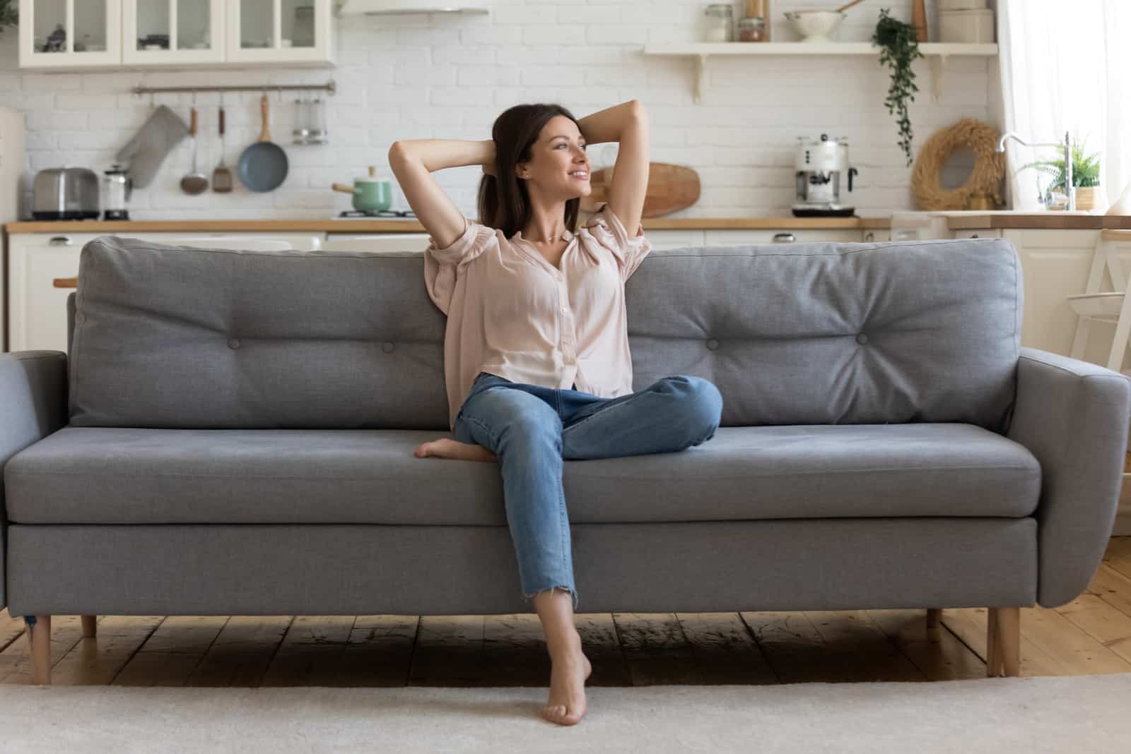 a smiling woman sitting on the couch