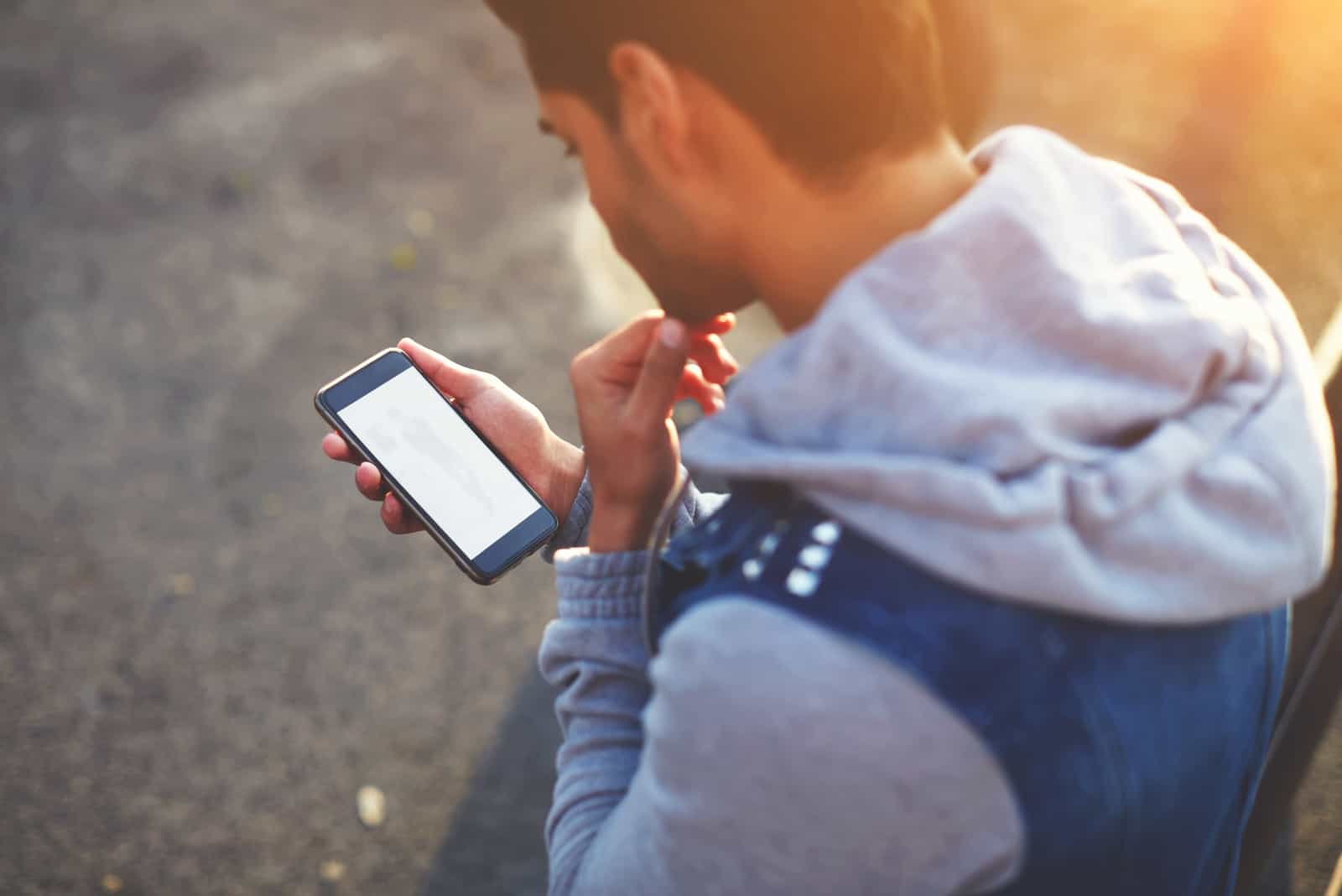 un hombre imaginario sostiene un teléfono en la mano