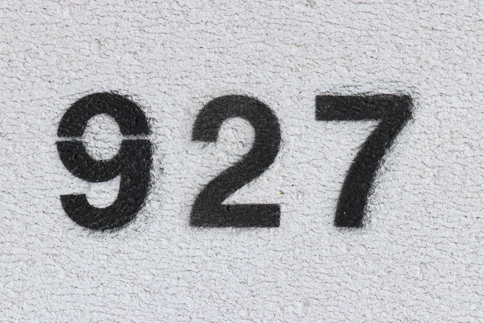 numero 927 nero su muro grigio