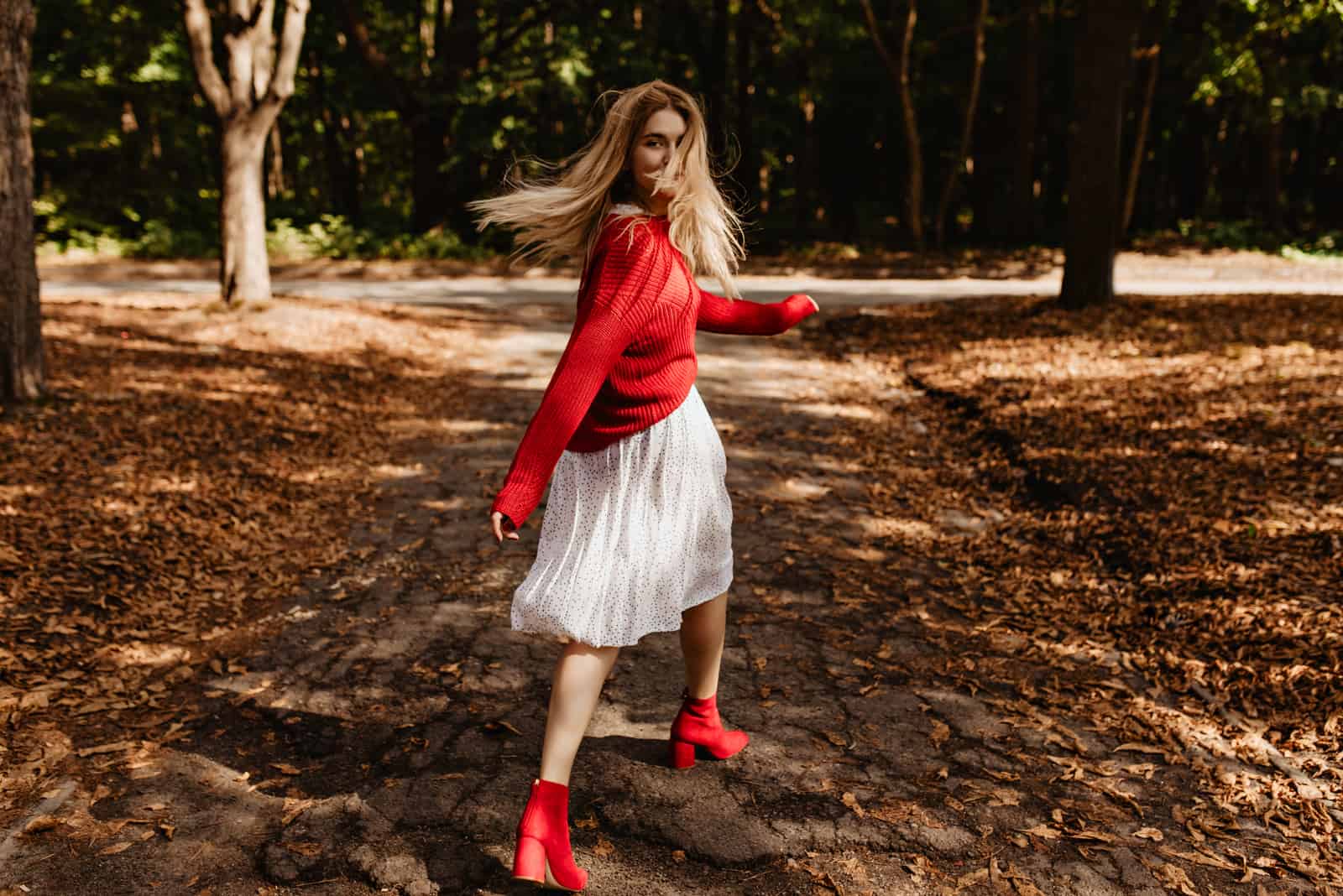 blonde girl in red ad whitewalking in park