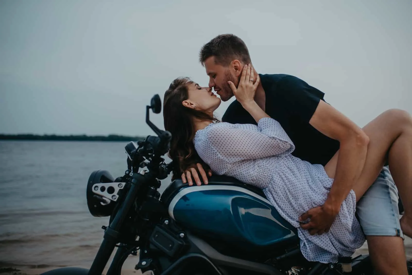 couple kissing on bike