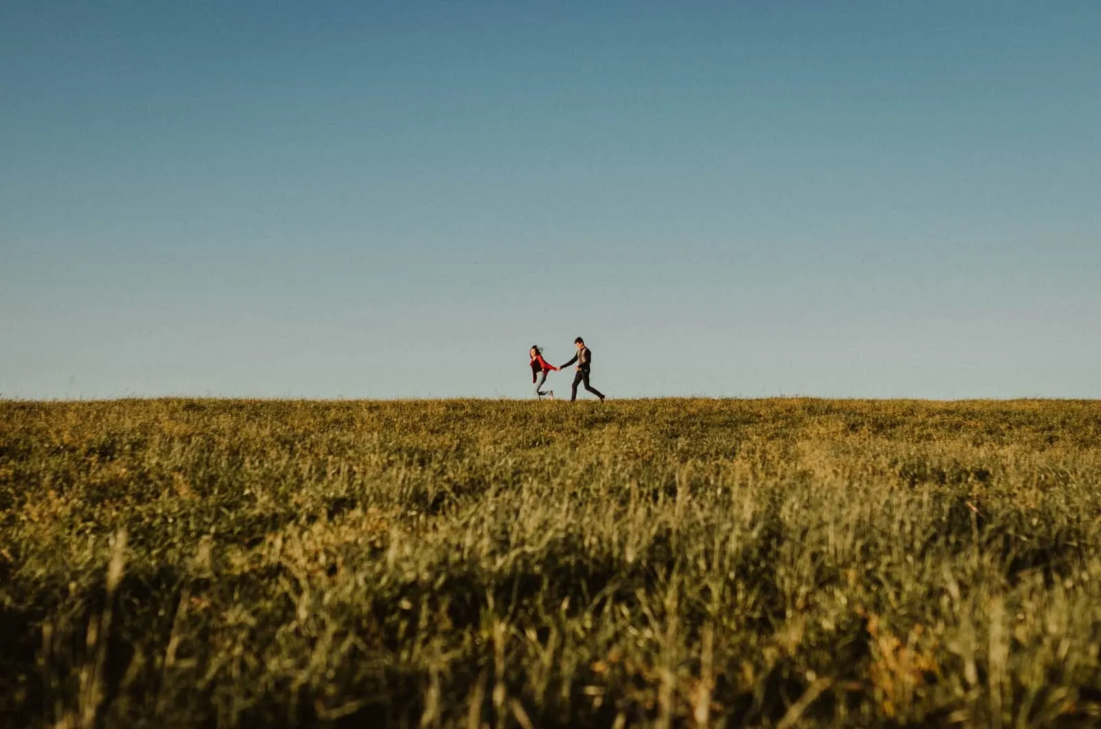 couple running in a field