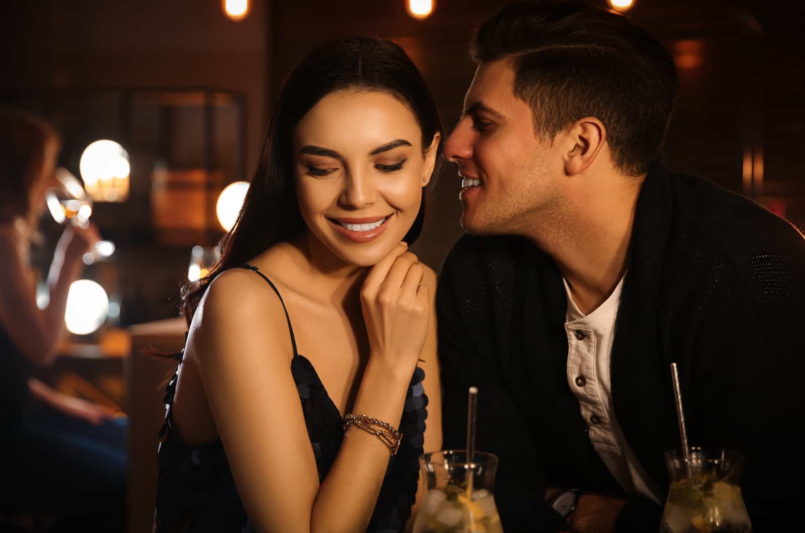 man and woman flirt at a bar