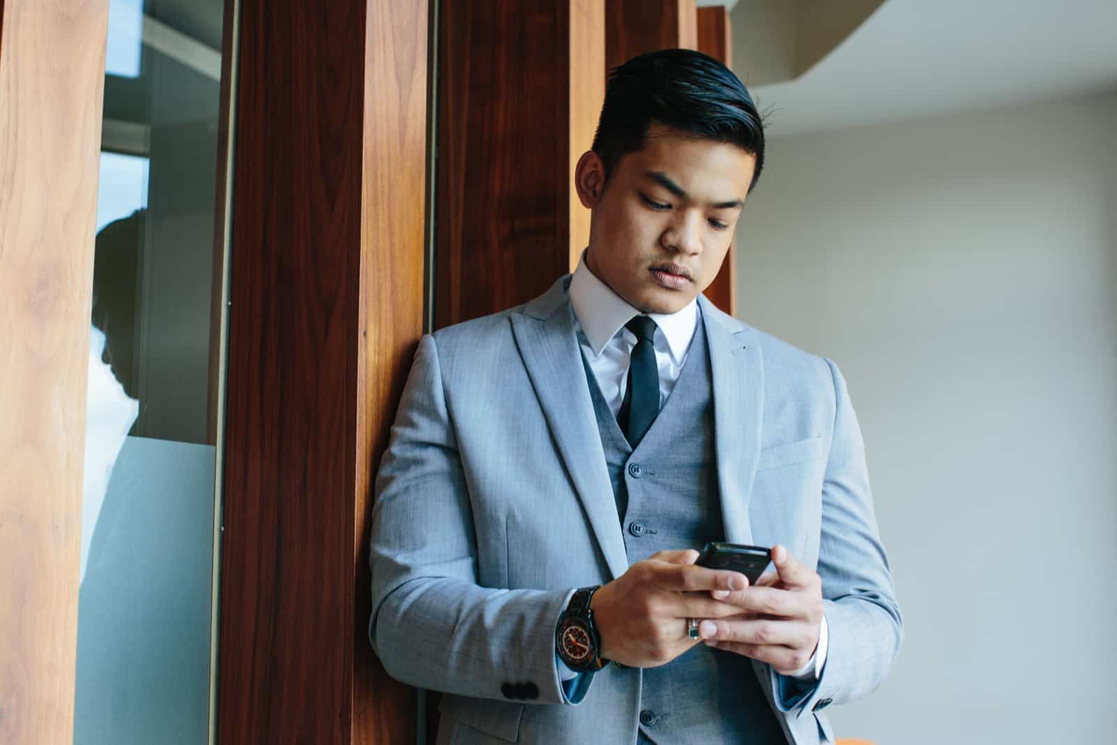 man texting before meeting