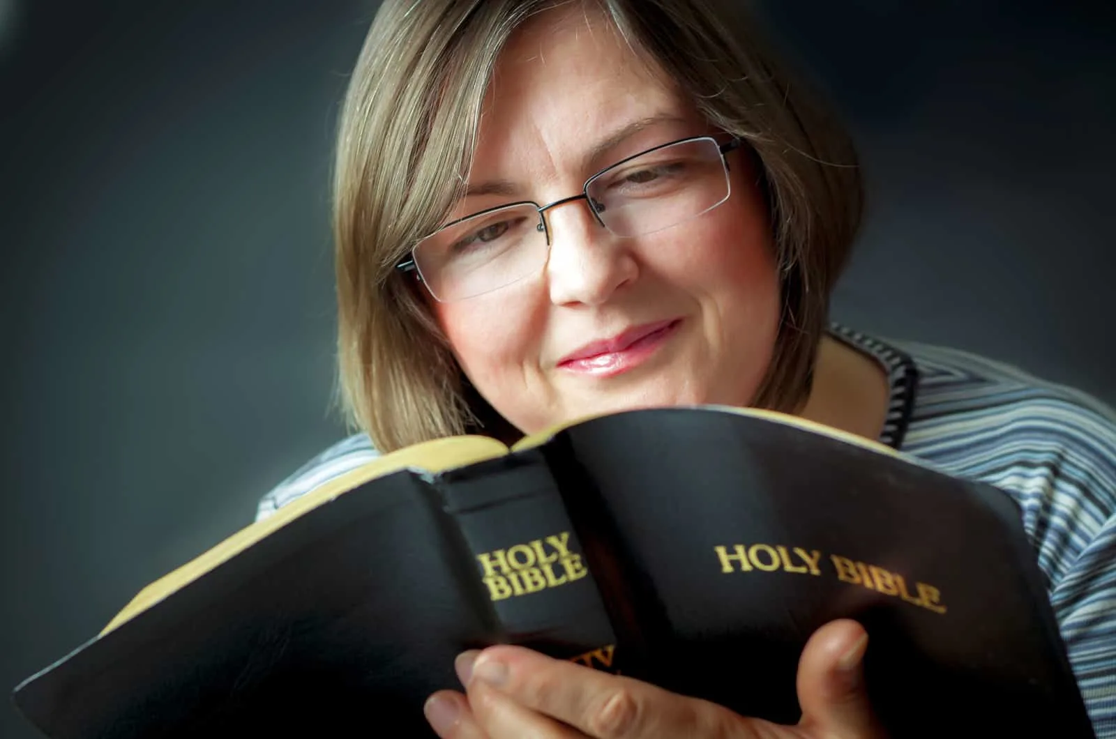 older woman reading bible