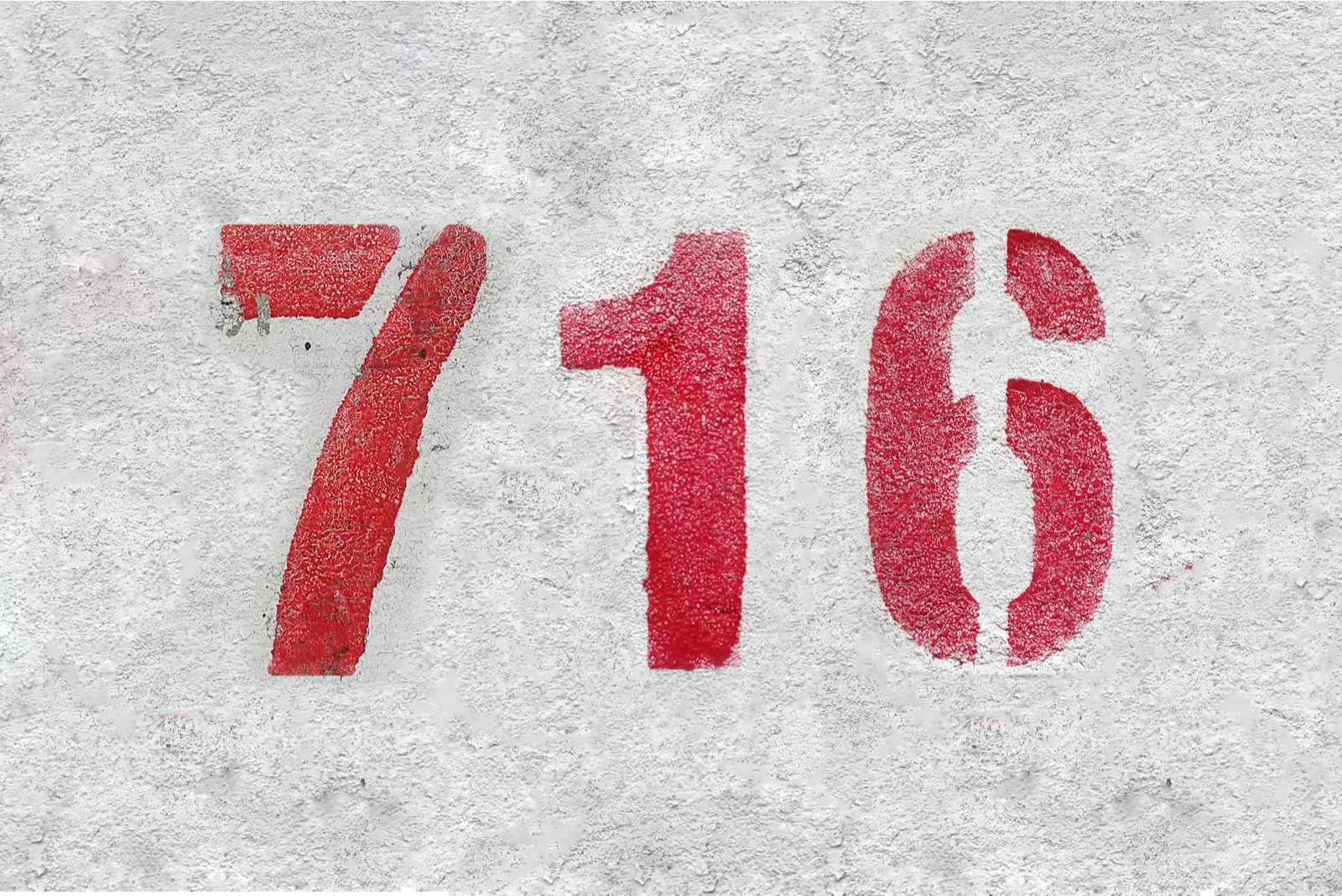 red number 716 on grey wall