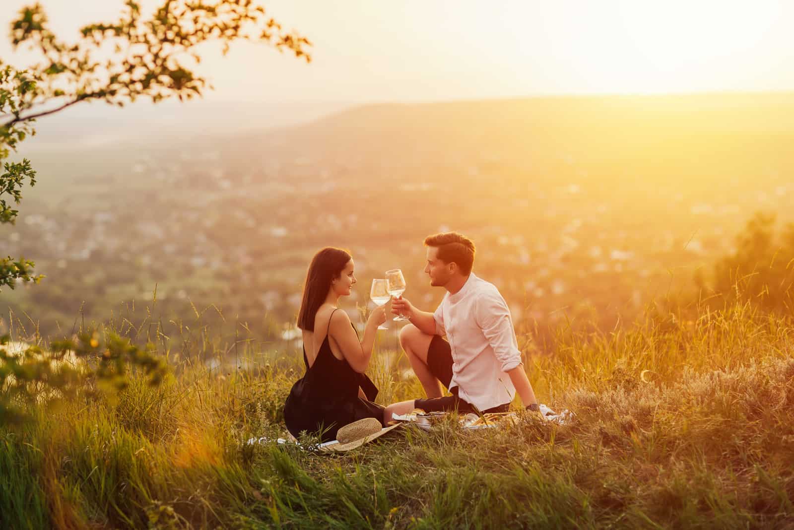 romantic picnic date on hill with view of city