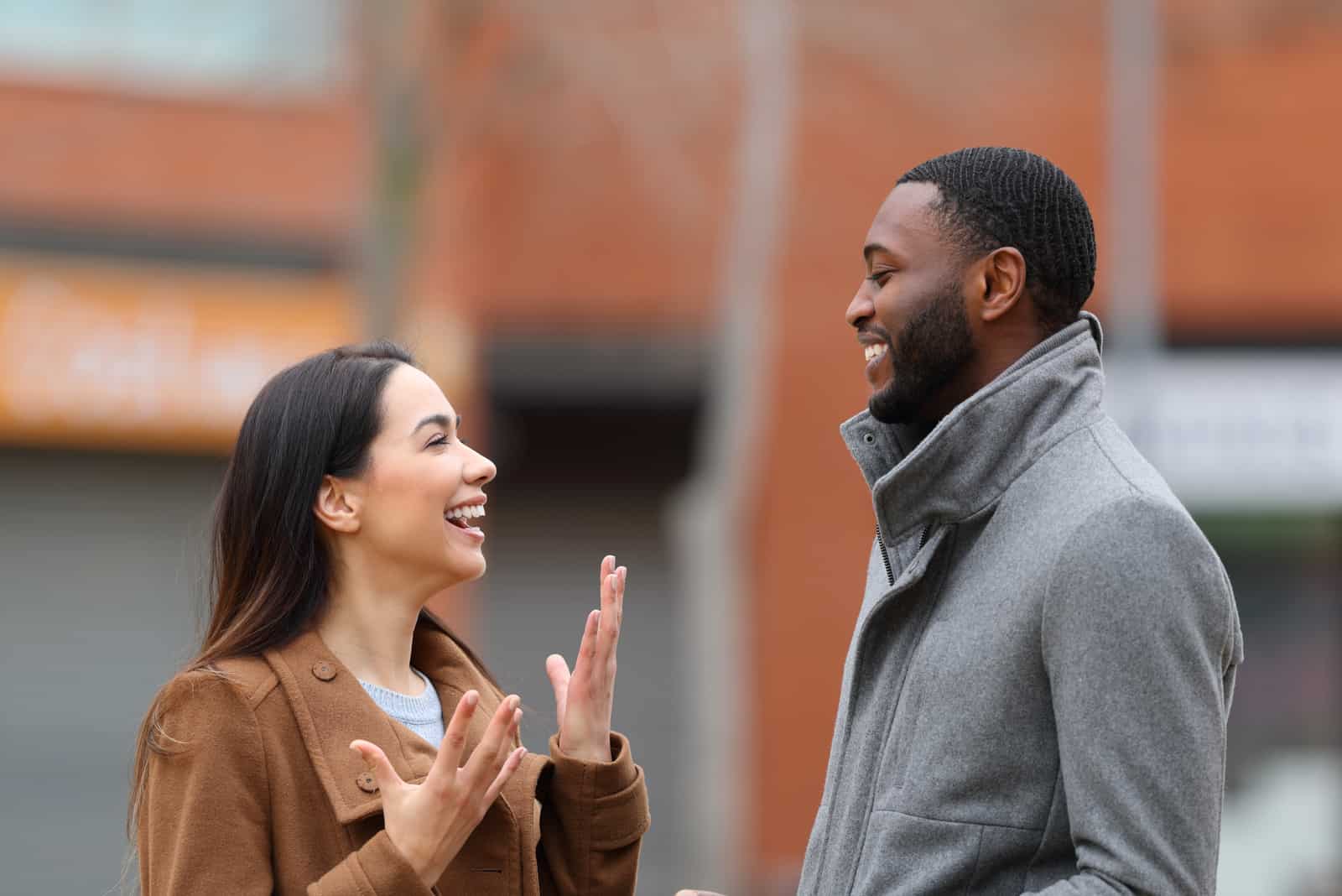 two people talking on street