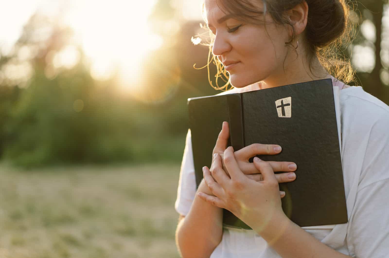 woman in park holding bible