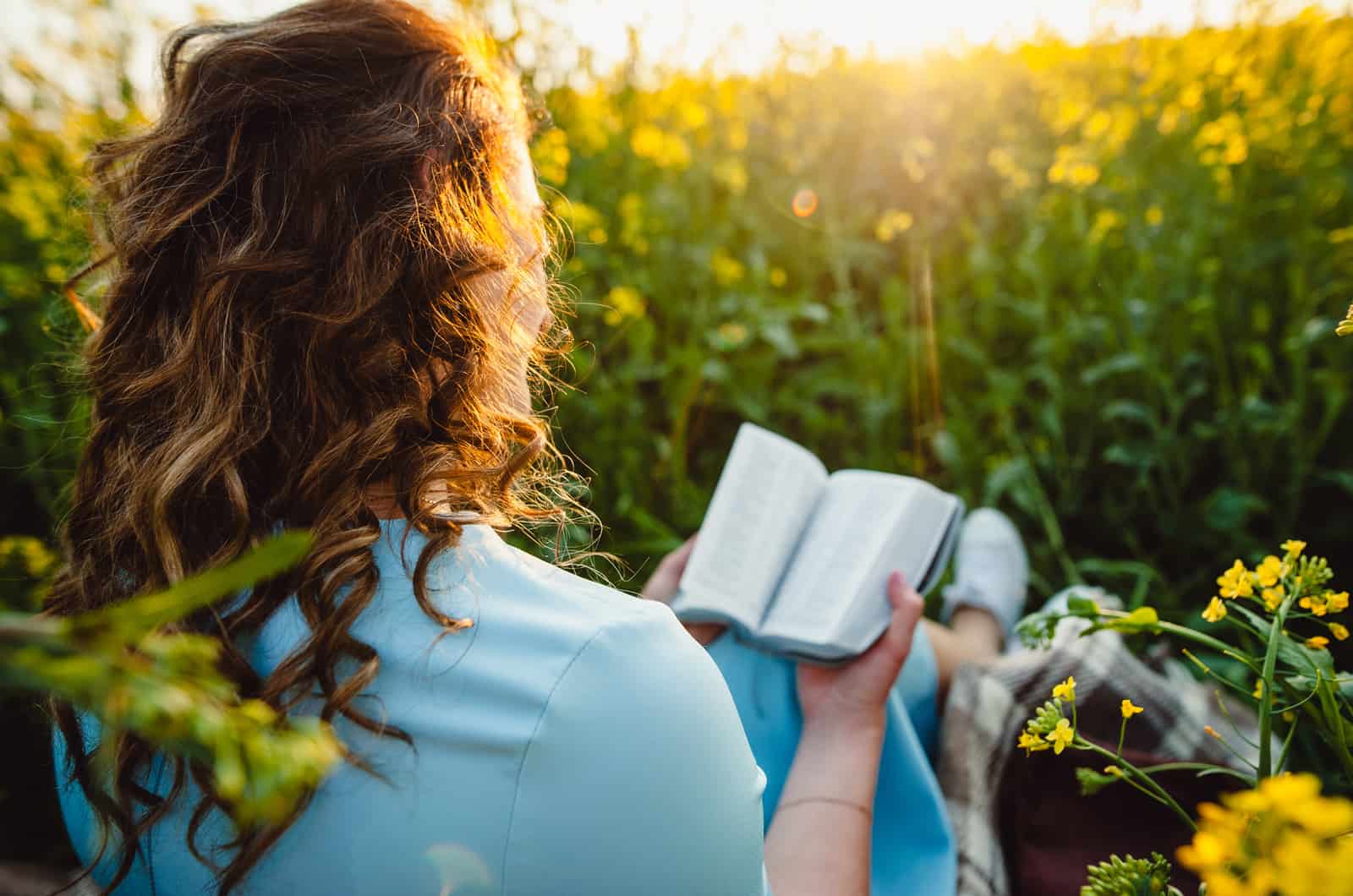 woman reading bible in nature