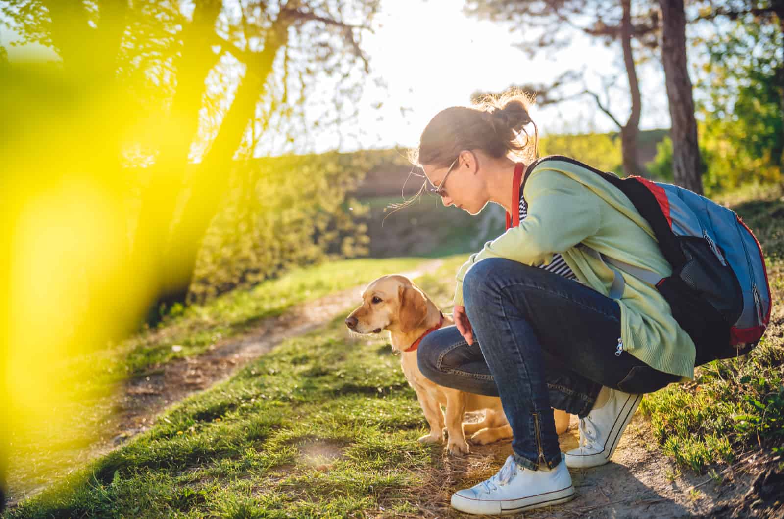 woman with her dog outside in nature