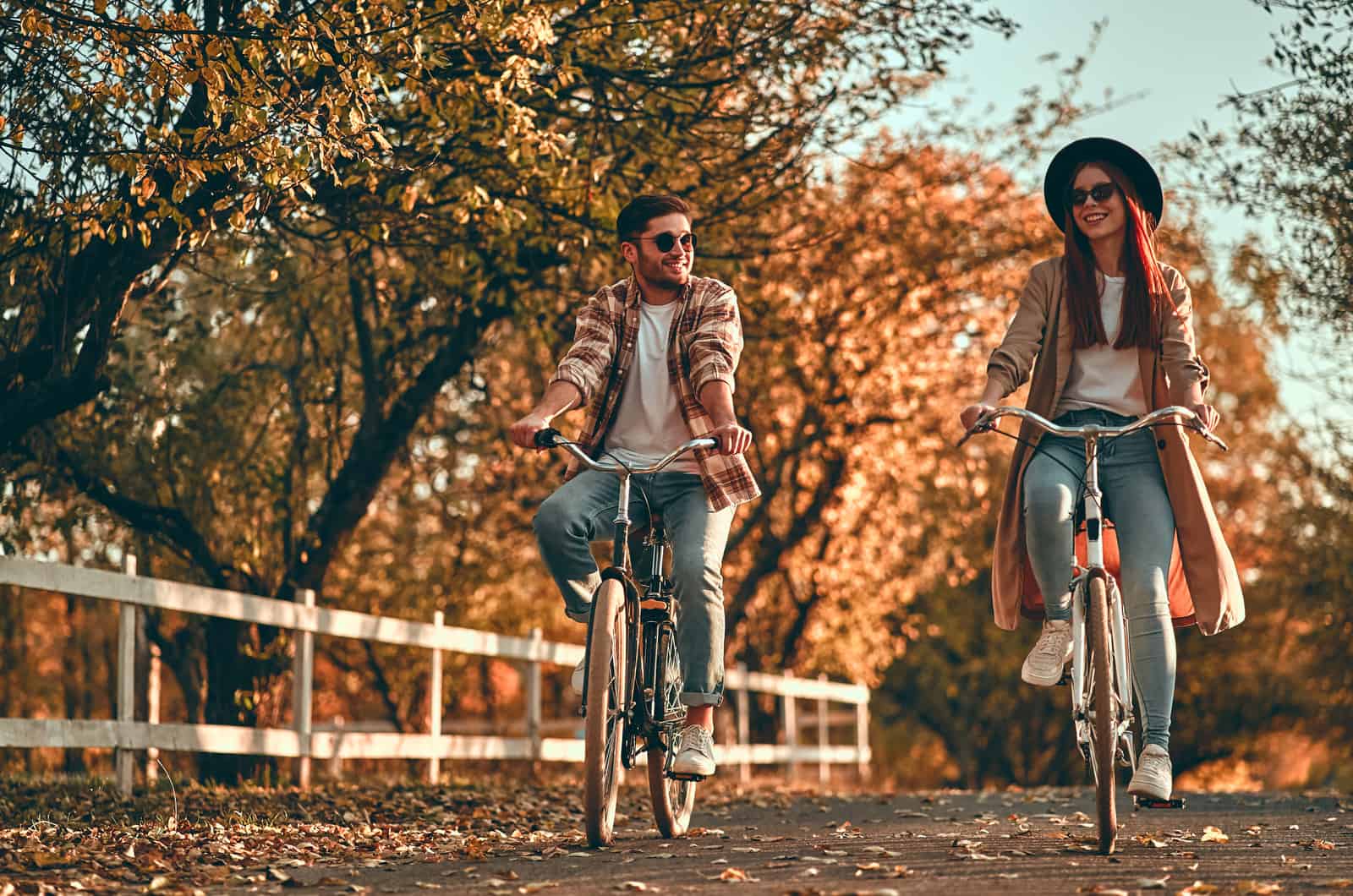 youg couple riding bikes in park