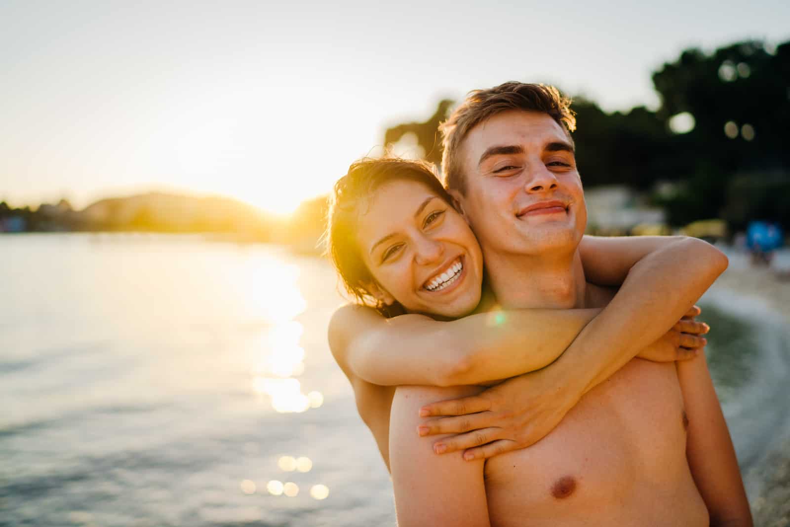 young couple hugging on beach