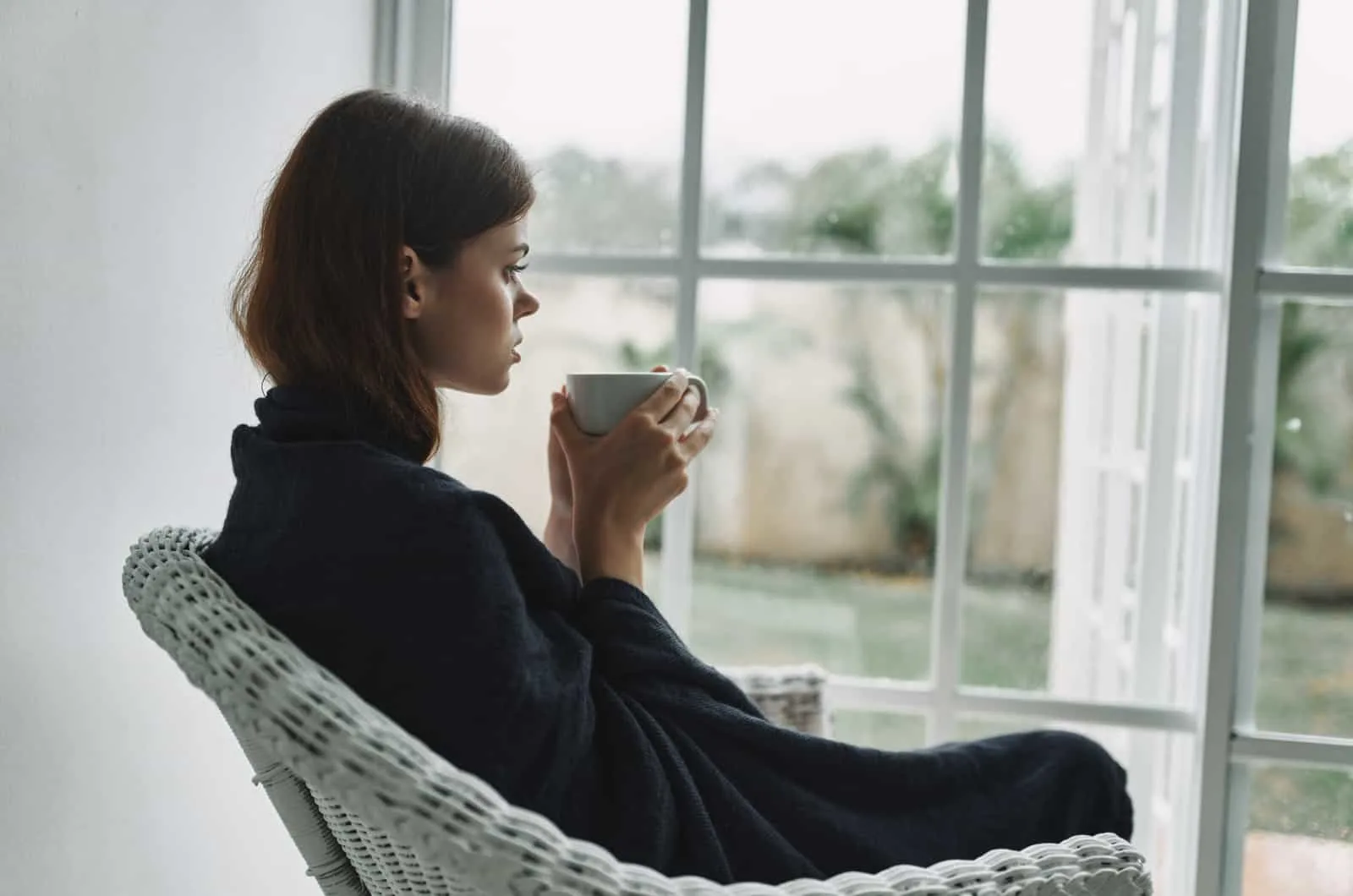 young woman sitting and drinking coffee