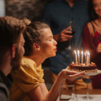 woman blowing candles