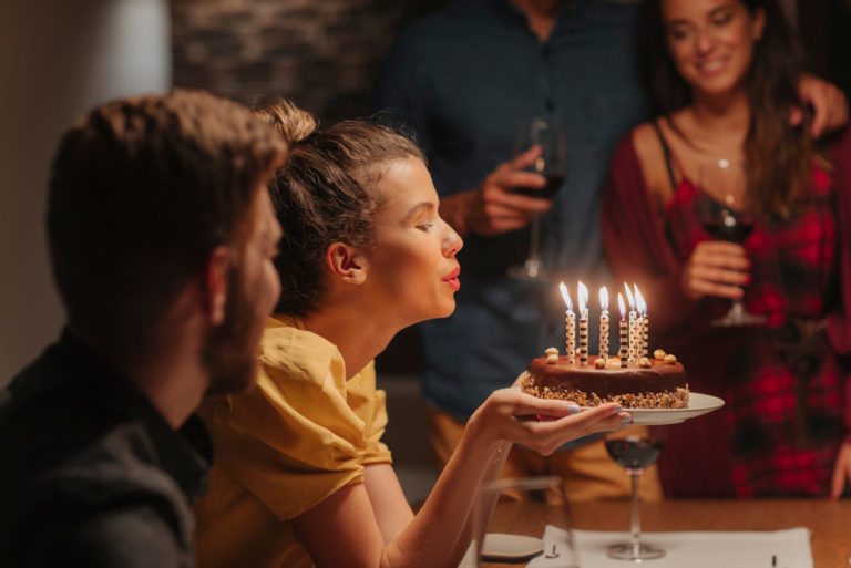 woman blowing candles