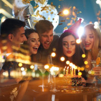 smiling woman celebrating birthday with friends