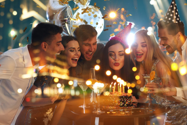 smiling woman celebrating birthday with friends