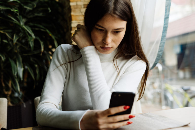 woman typing on phone