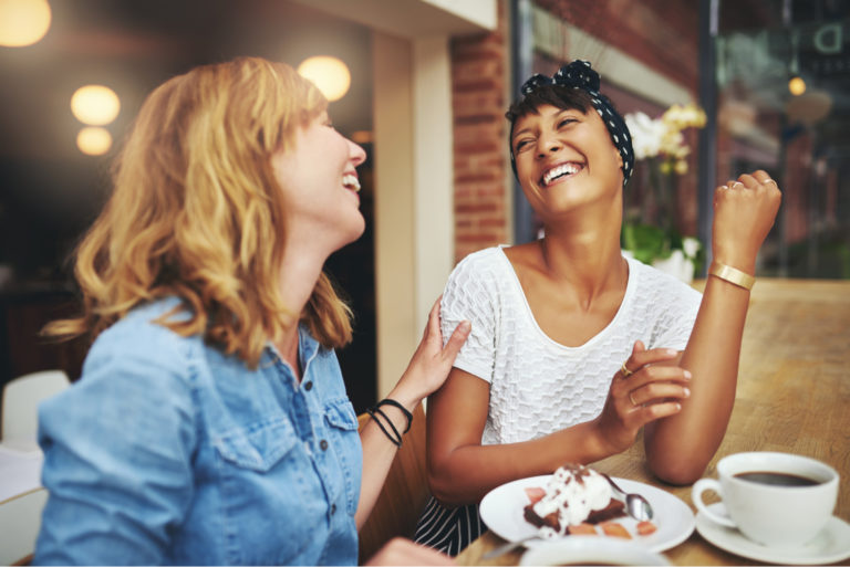 two girl friends laughing and having fun