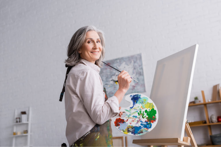 woman painting on canvas