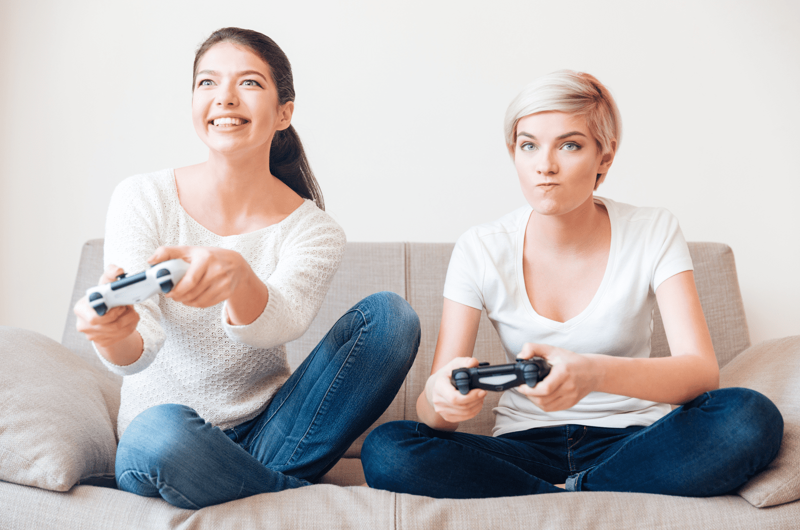Two girlfriends playing video games
