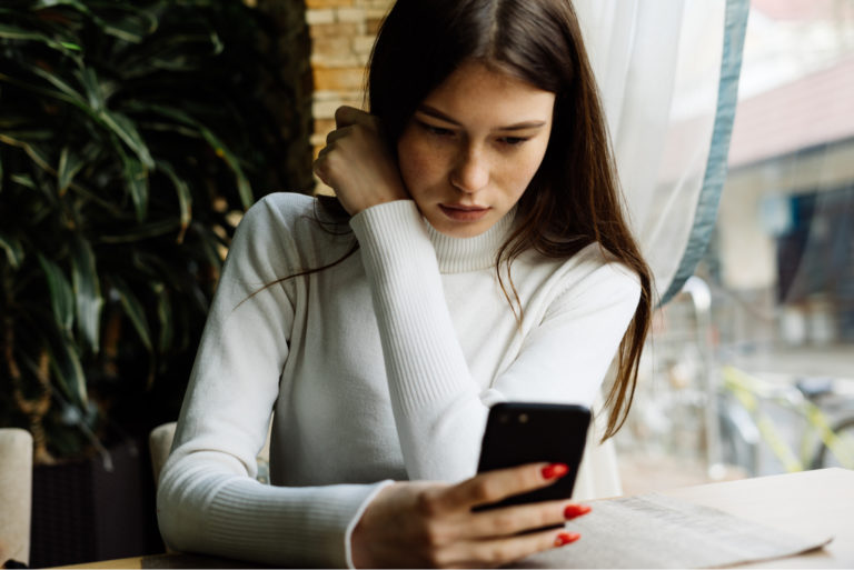 disappointed woman key on phone