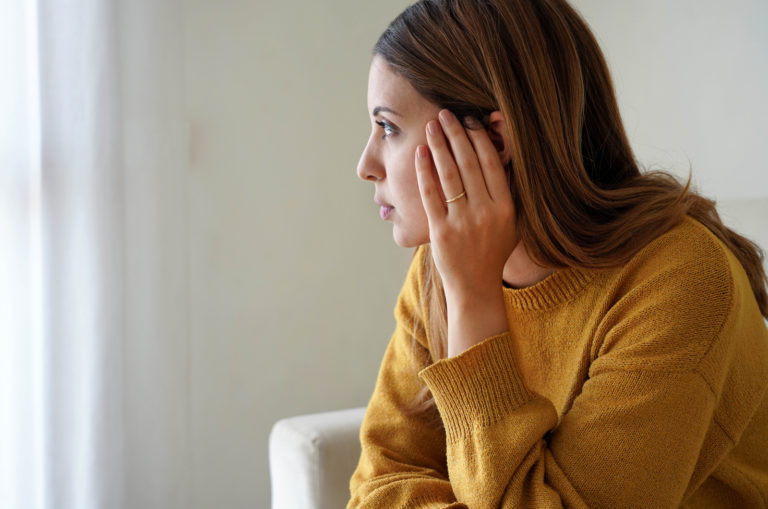 sad woman sitting alone and thinking