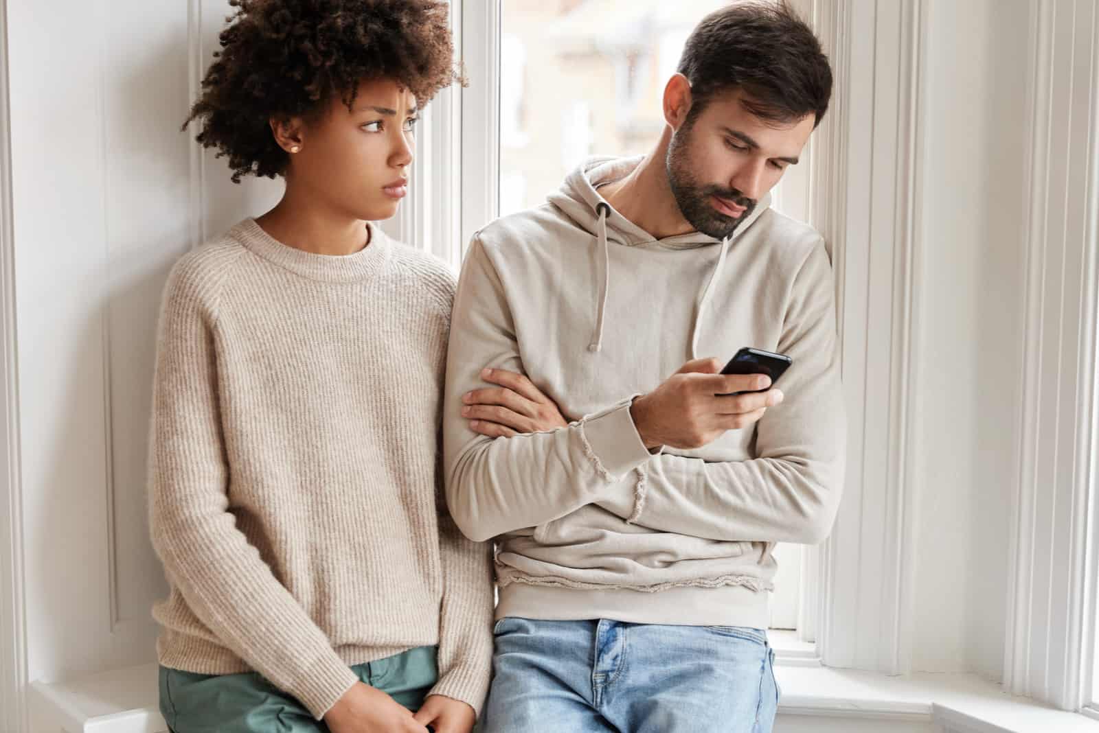 a disappointed woman stands next to a man