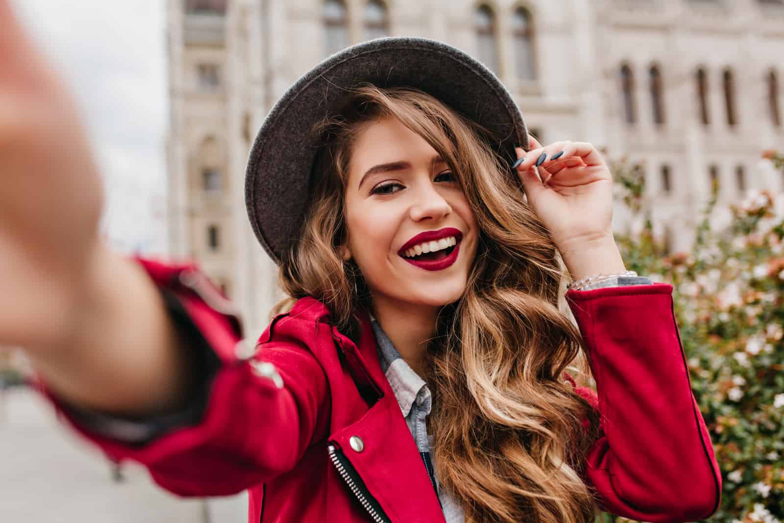 a smiling woman with a hat on her head