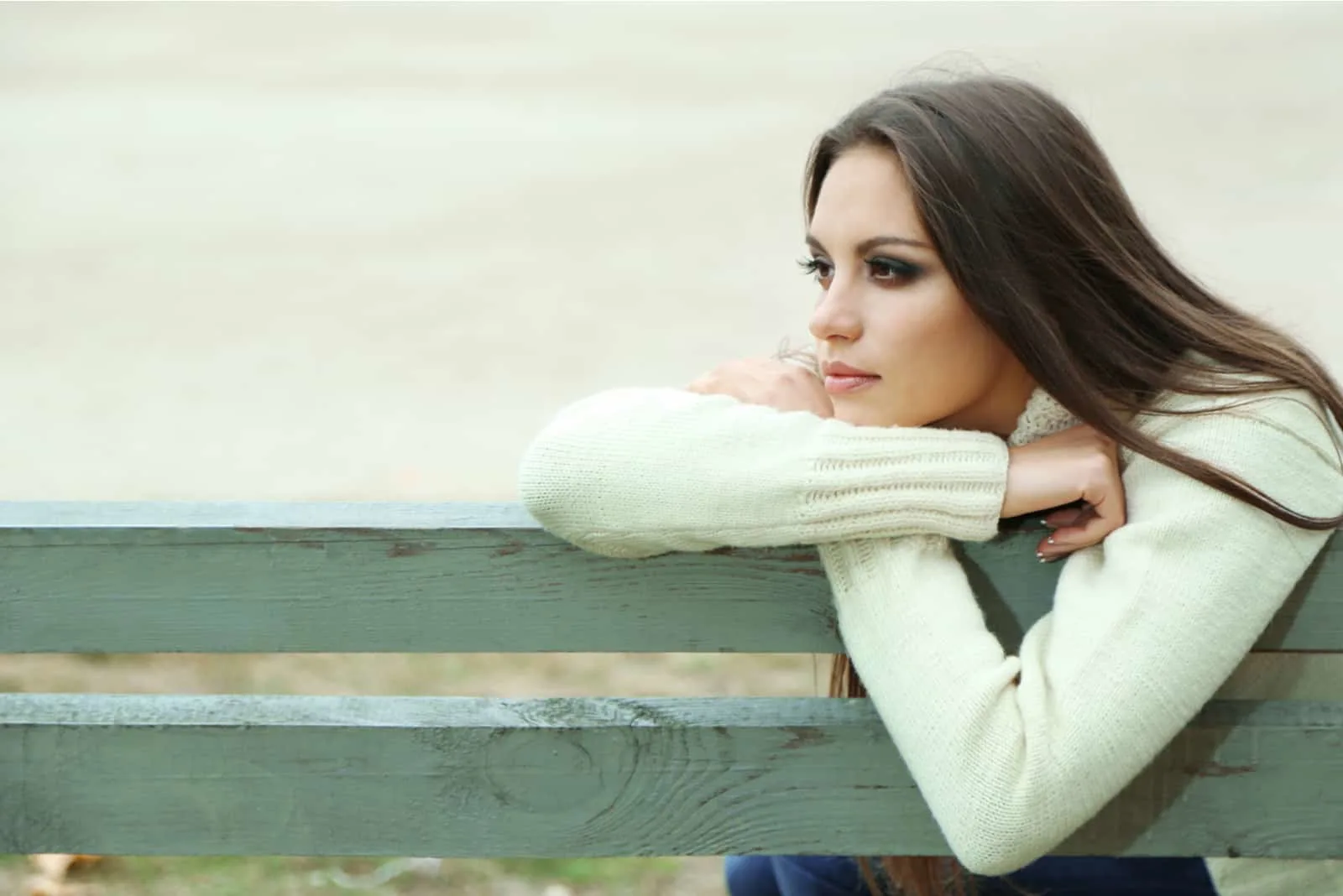 an imaginary woman leaning on a bench