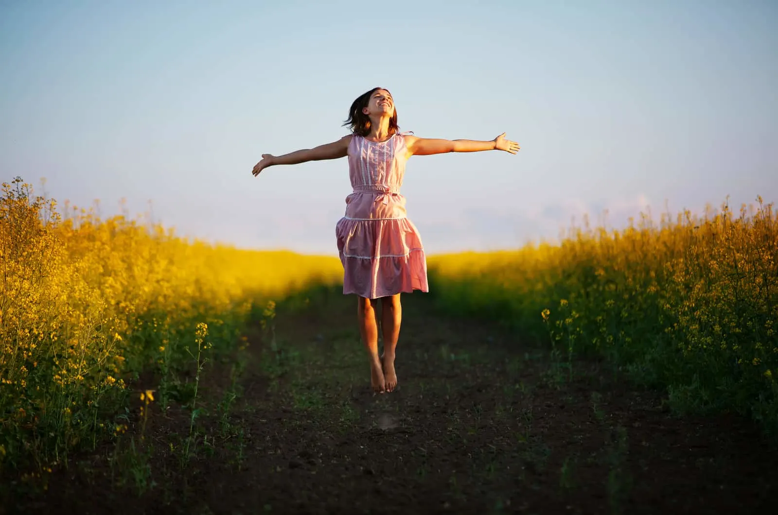 happy woman jumping in field