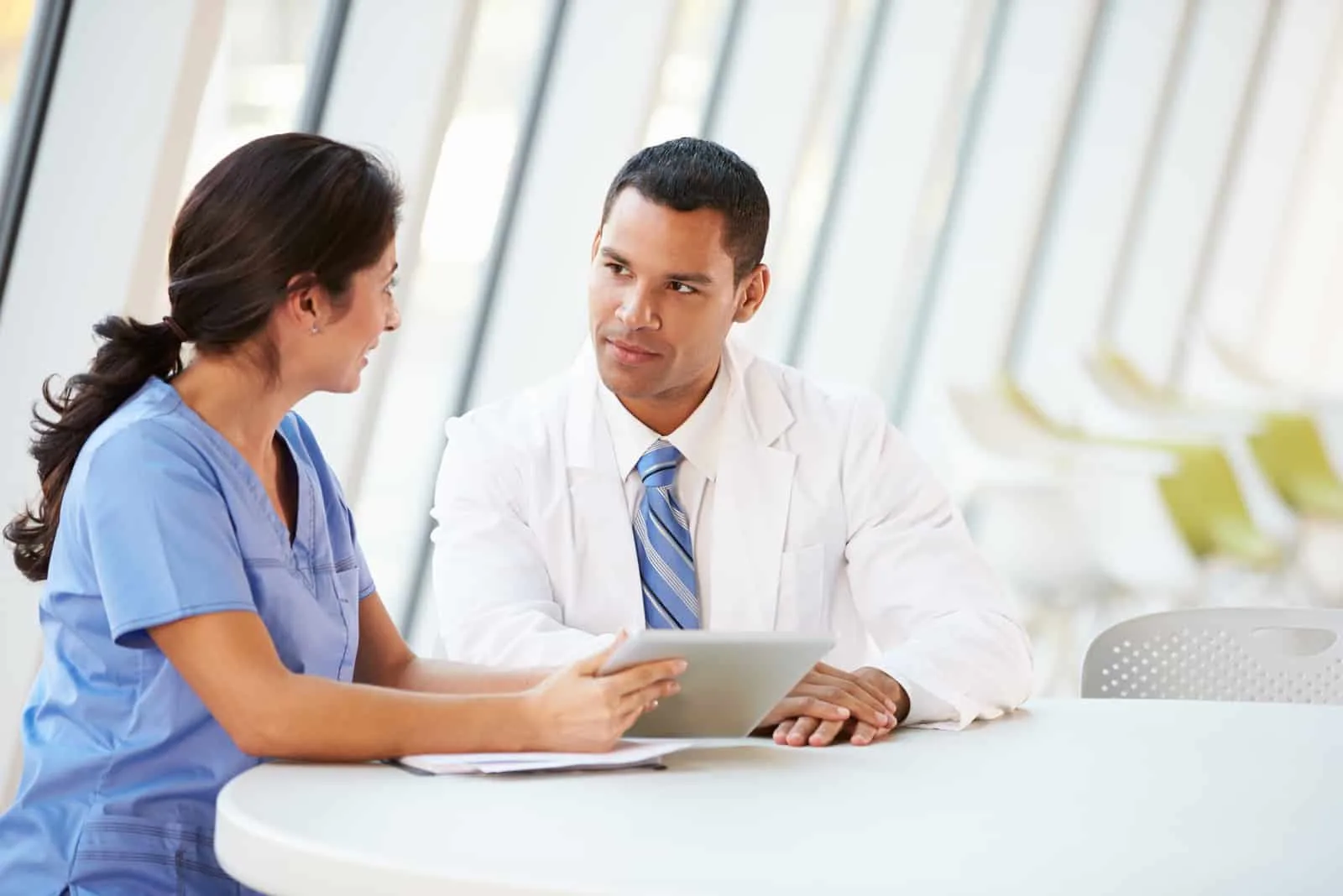 male and female nurse talking in hallway