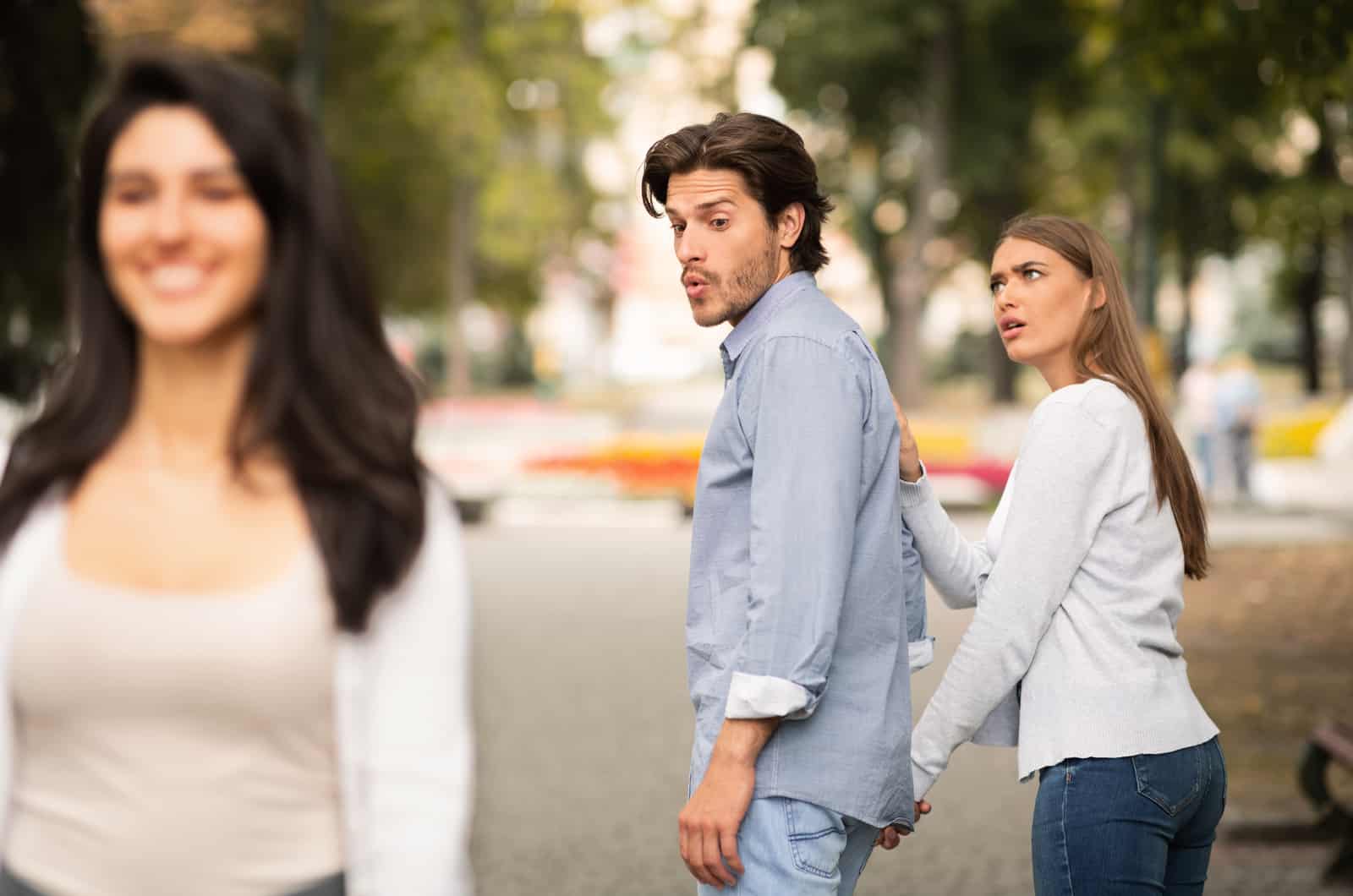 man with girlfriend catcalling other girl