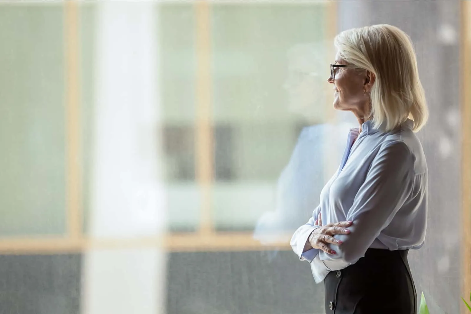 older woman standing by window