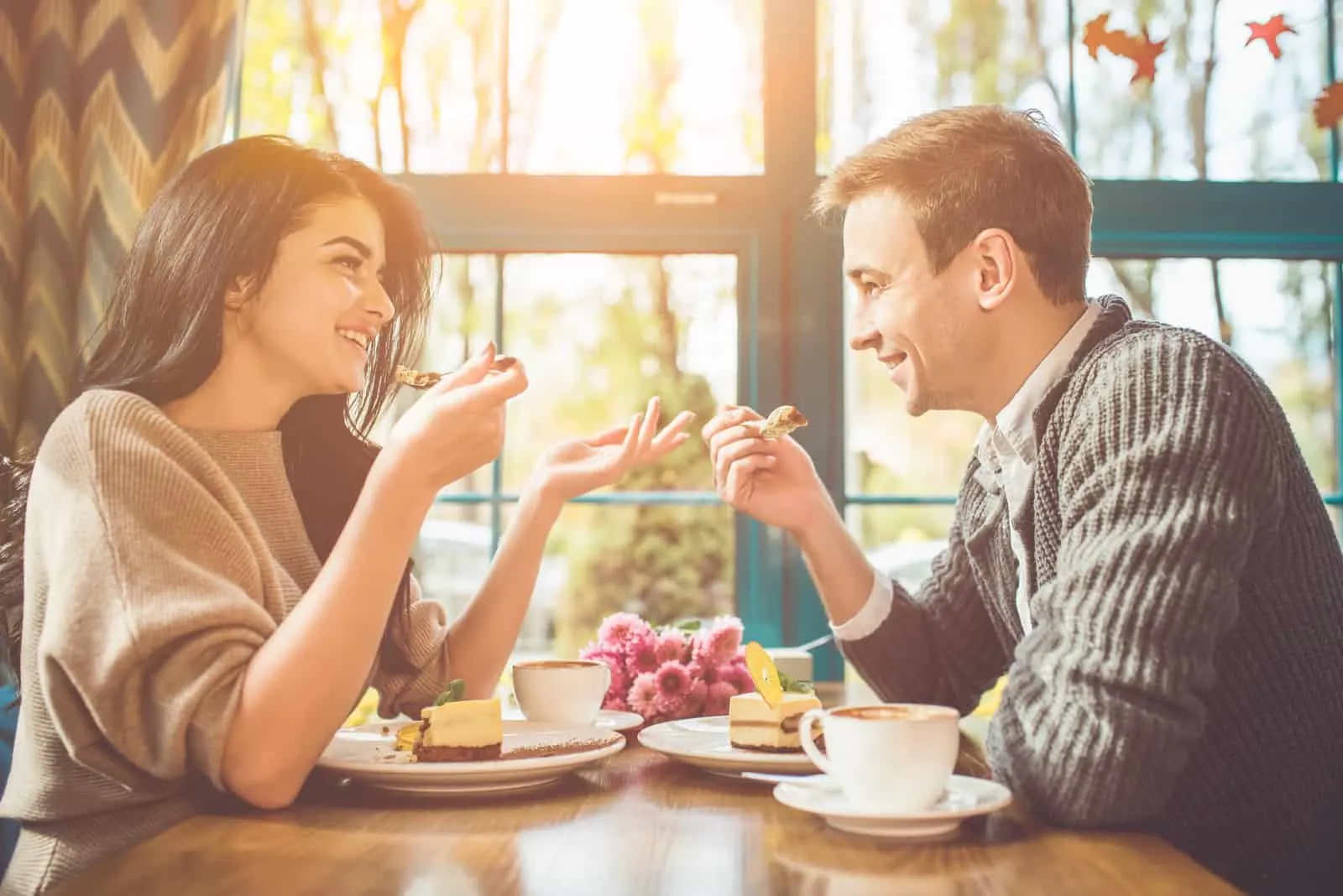 smiling loving couple talking while eating