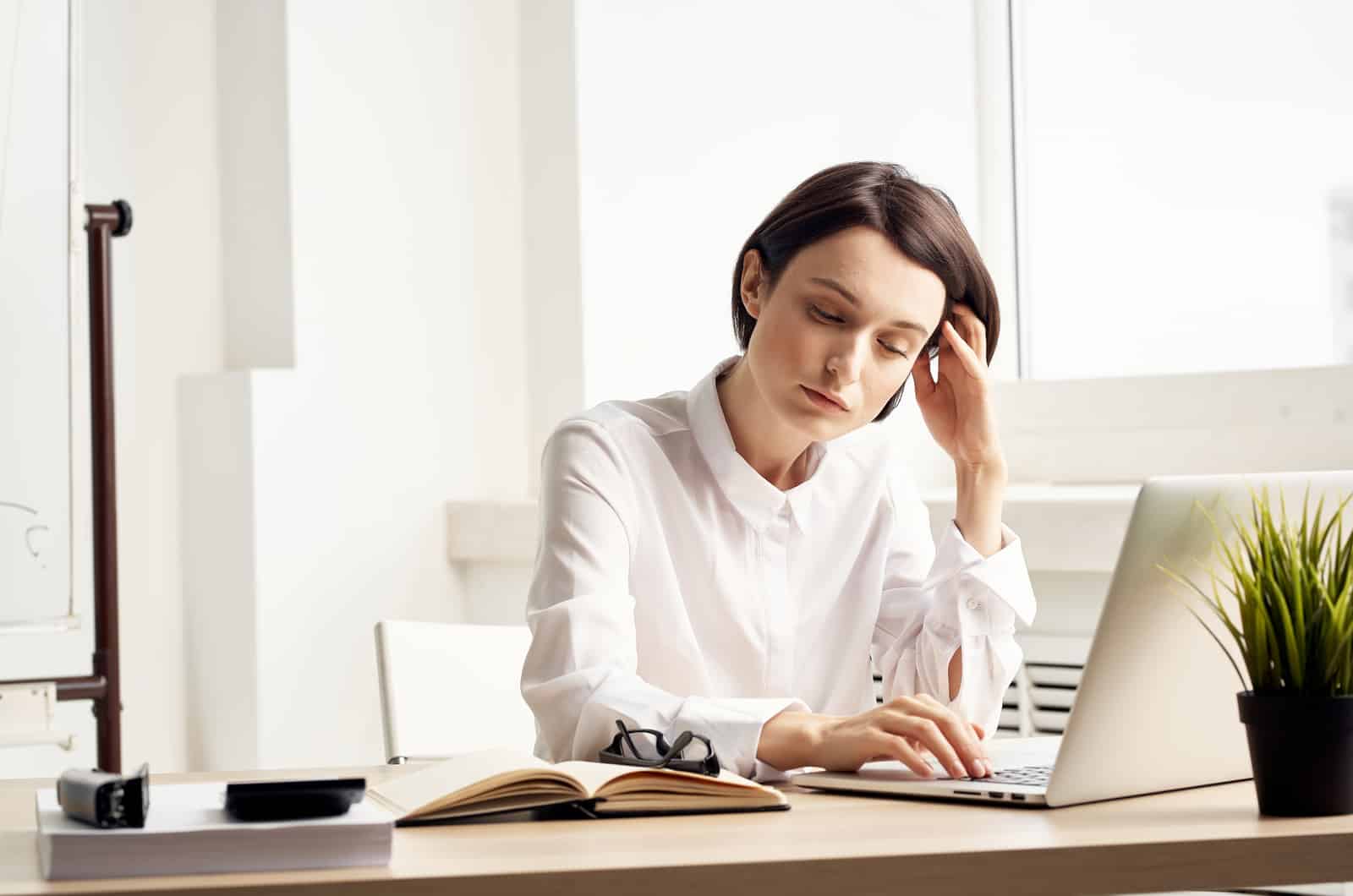 tired young woman working in office