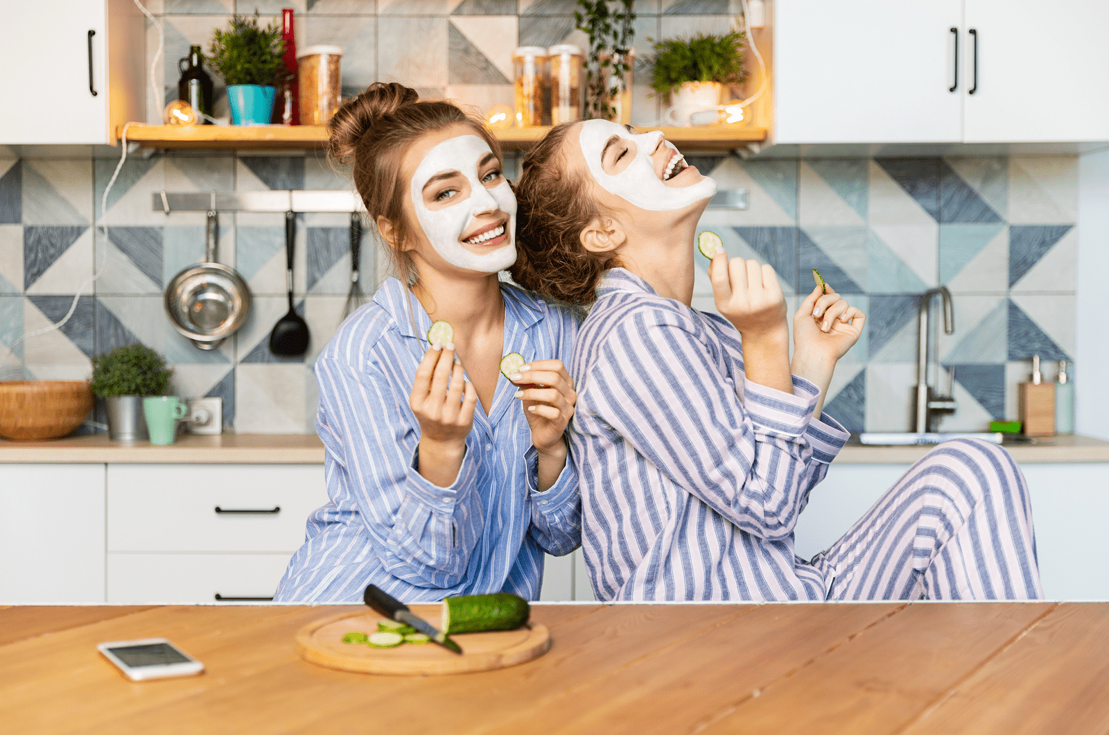 two best friends laughing and having fun on kitchen
