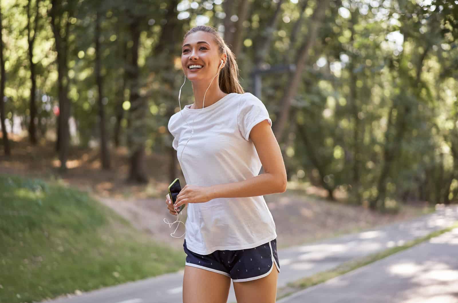 woman listening music while running outdoor