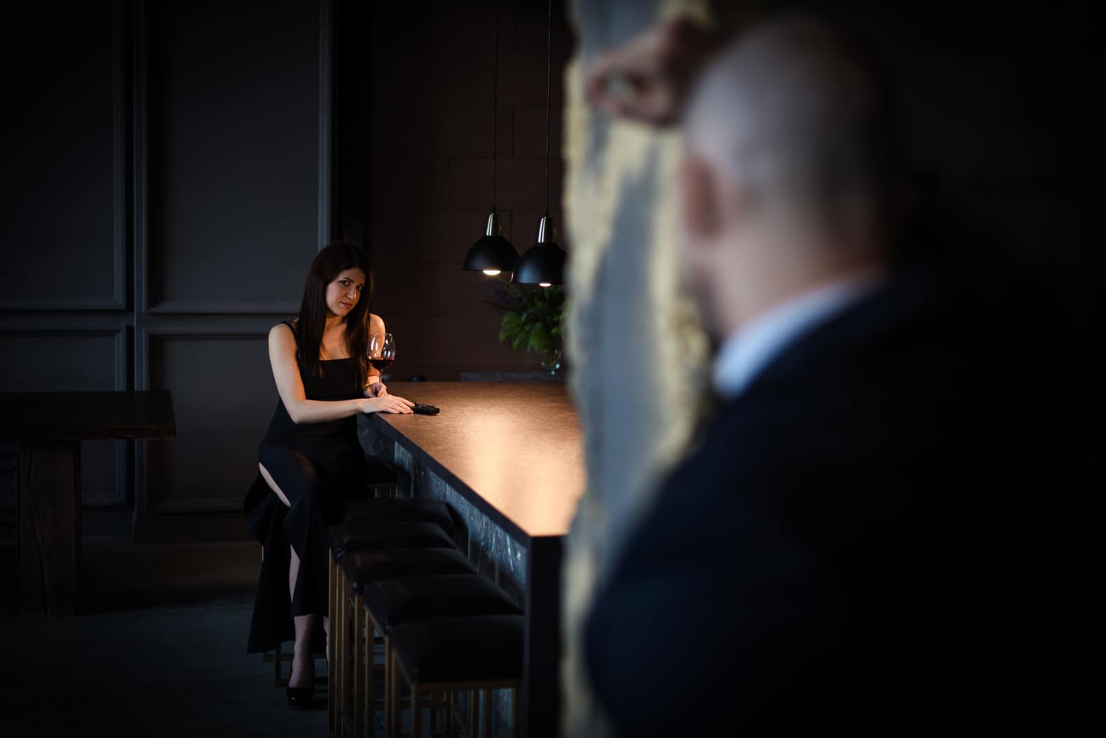 woman looking at a men in bar