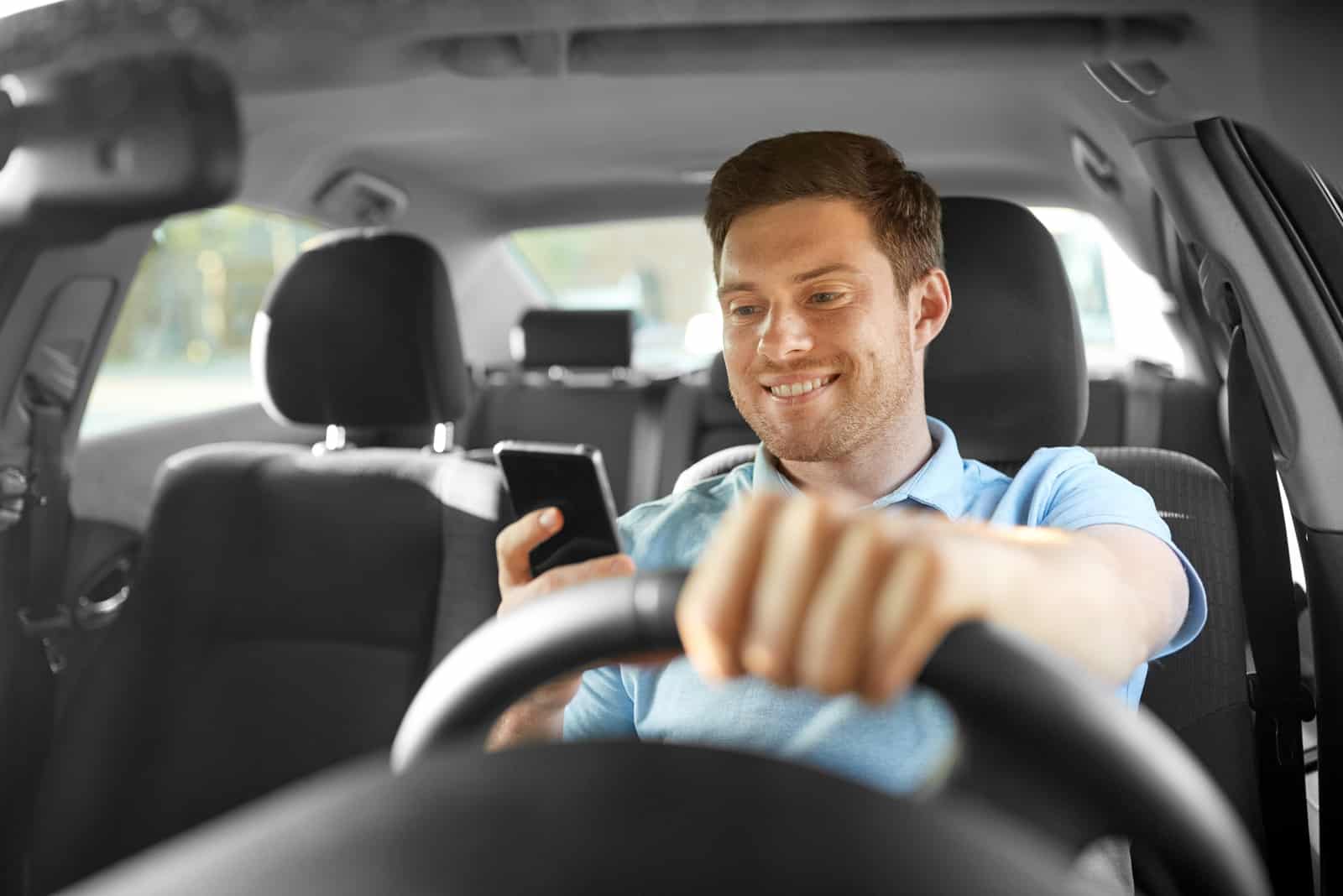 young man reading his messages while driving