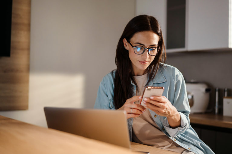an imaginary woman sitting at a table and pressing a phone