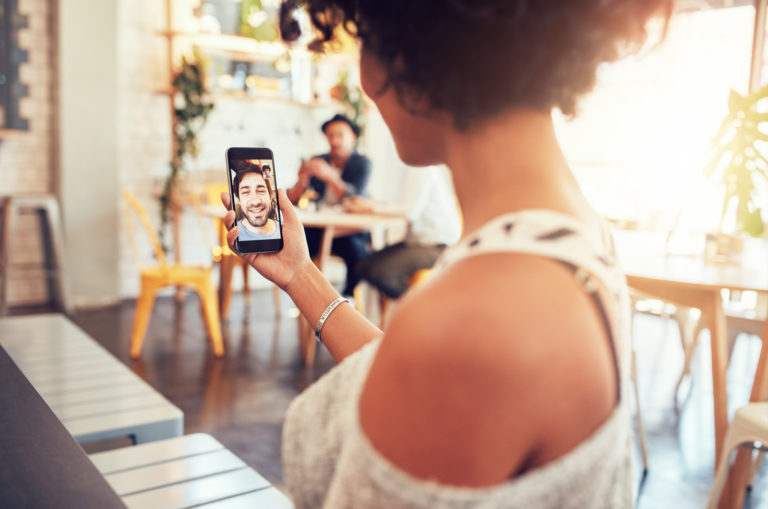 woman holding phone and talking with her long distance boyfriend