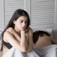 woman sitting on bed