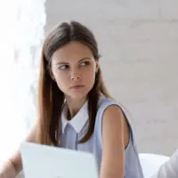 woman stares at her colleague angrily