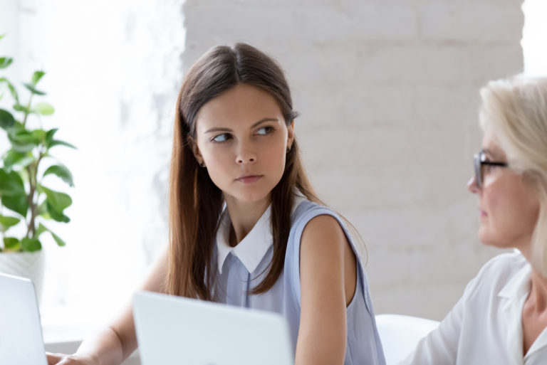 woman stares at her colleague angrily