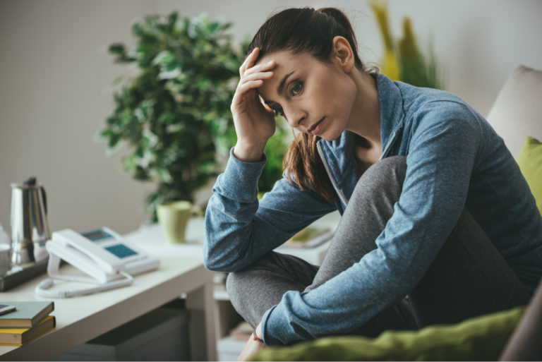 sad woman sitting on sofa