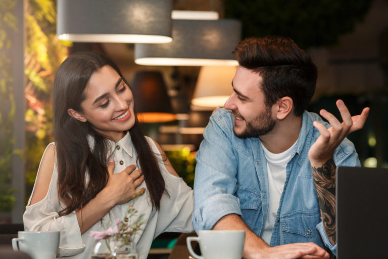 attractive woman flirting with man at cafe